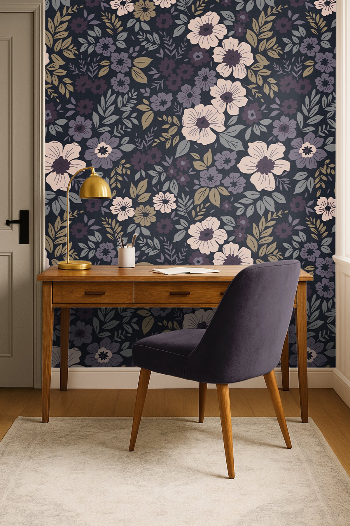 plum floral wallpaper behind plum chair and warm wood office desk 