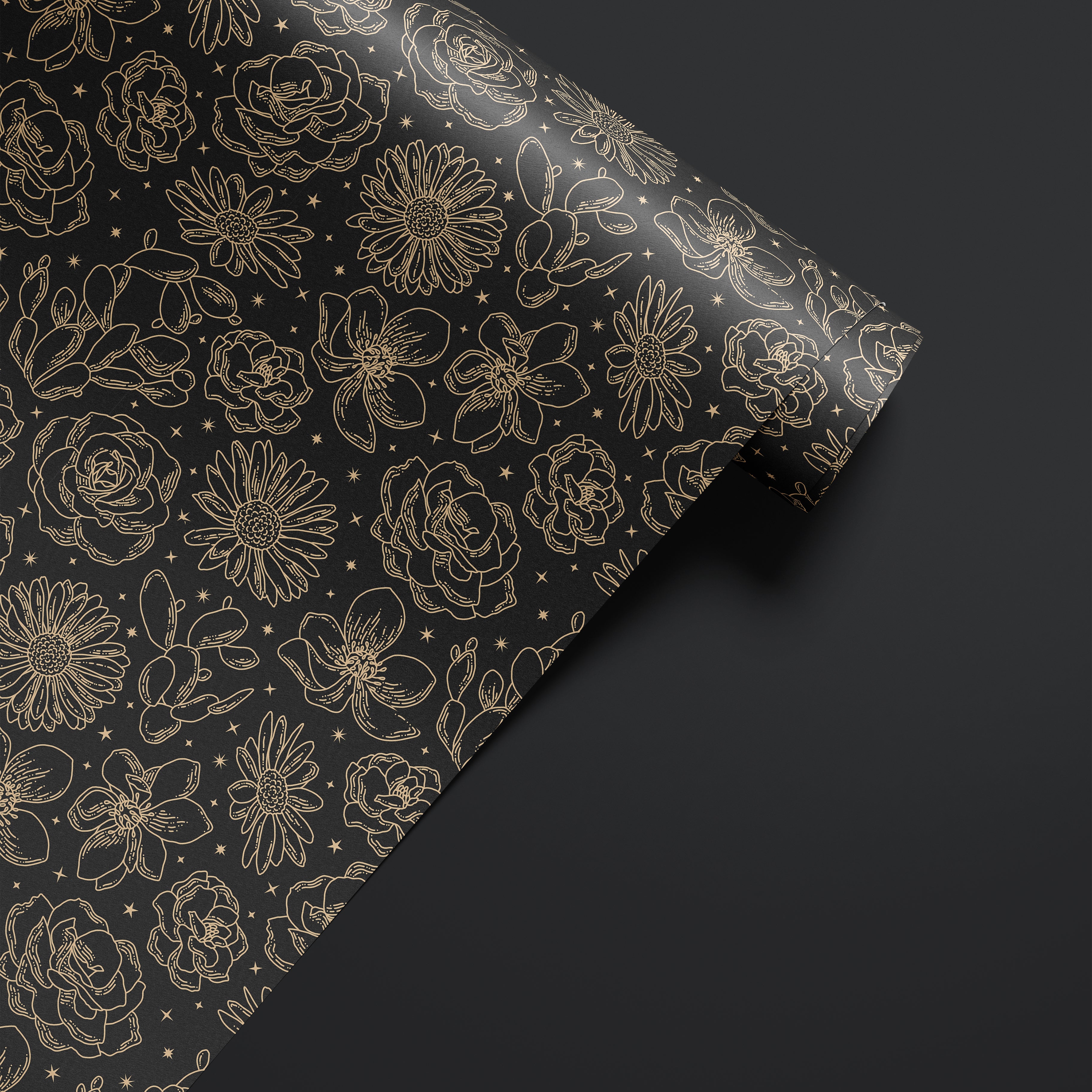Roll of Wild Noir dark floral contact paper with black and gold botanical sketch pattern.