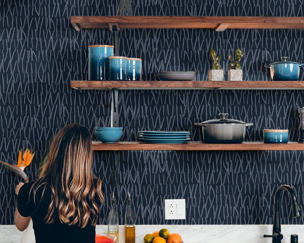 Navy blue abstract line wallpaper behind kitchen open shelving