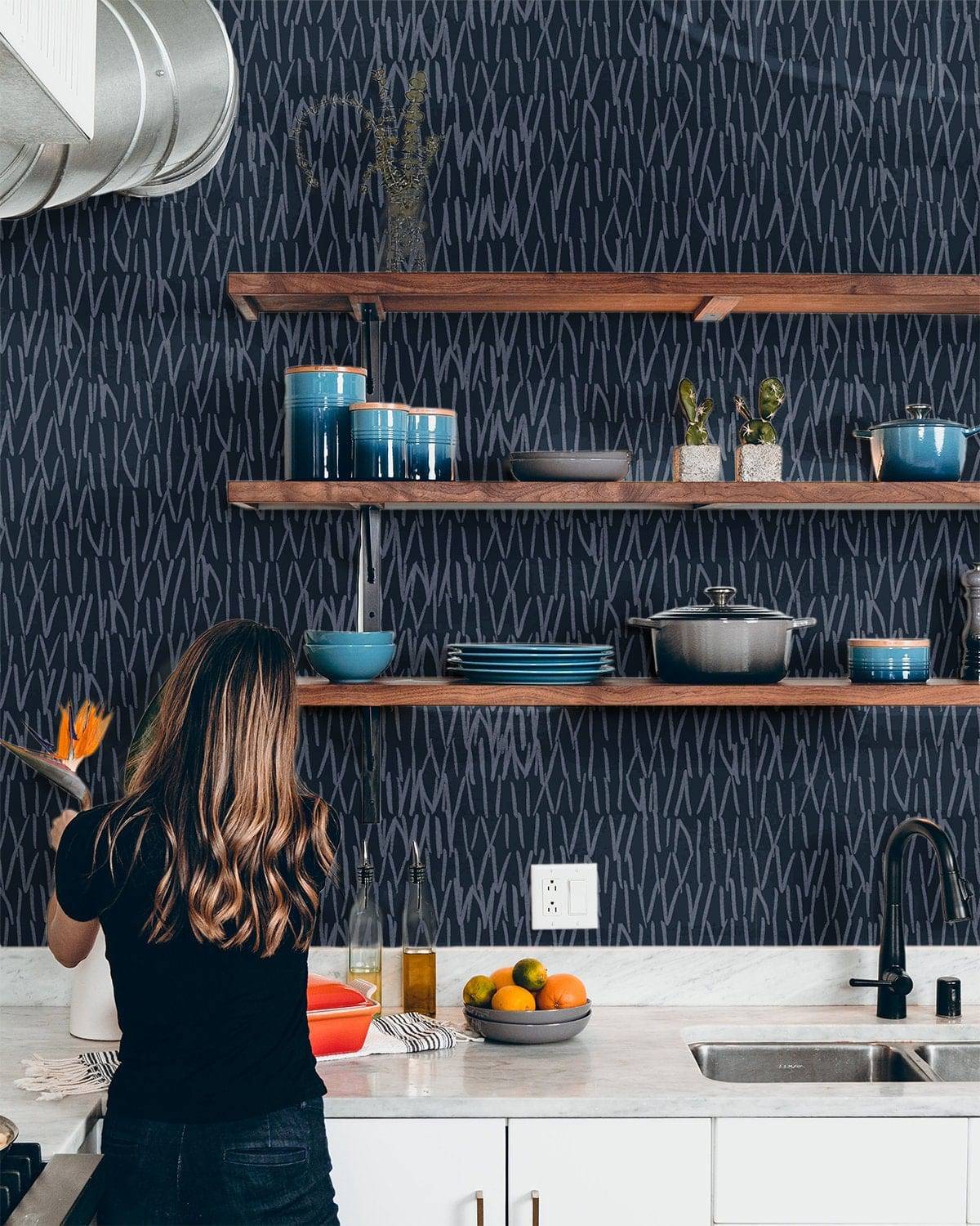 Navy blue abstract line wallpaper behind kitchen open shelving
