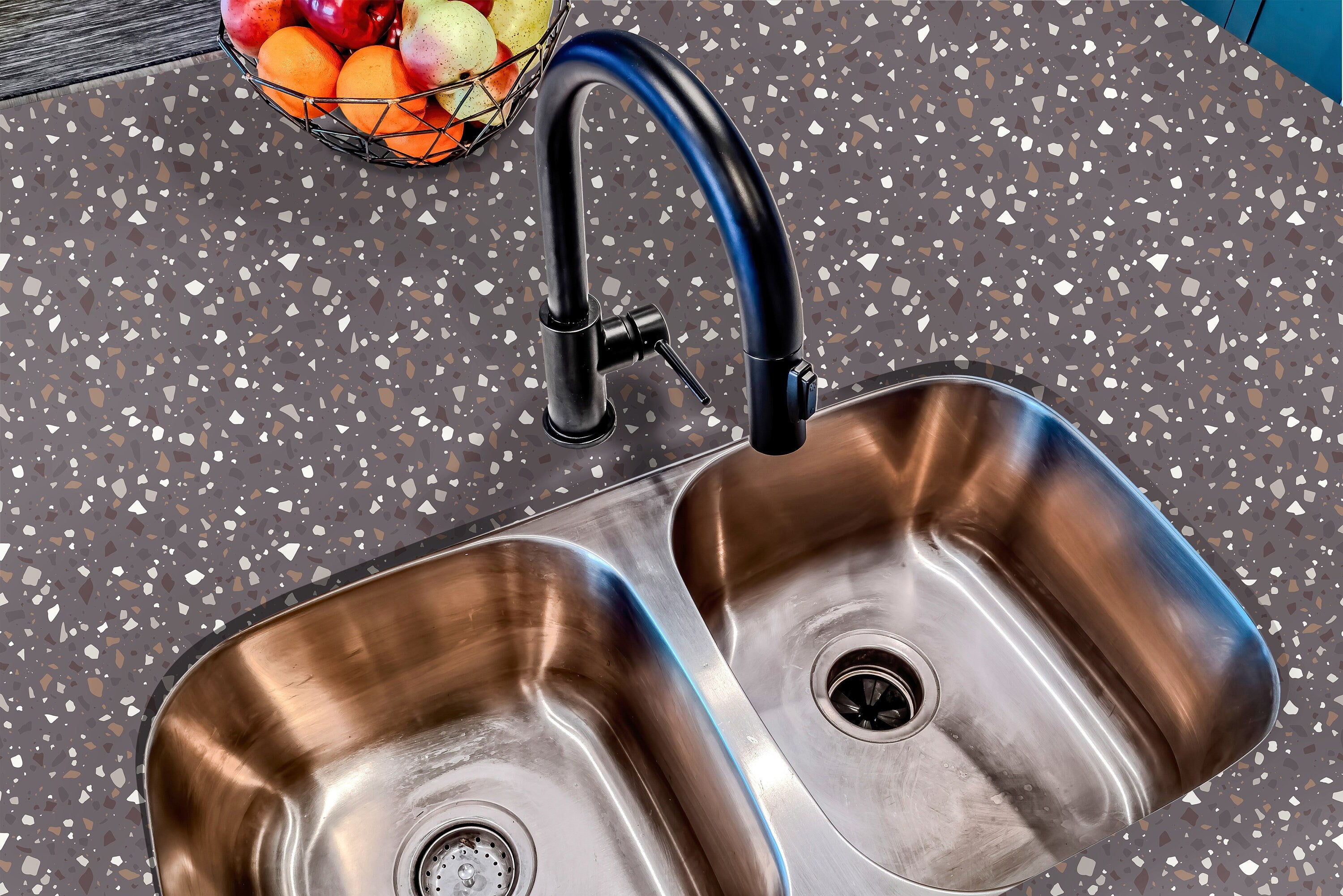 Countertop 23: A stylish kitchen countertop covered in dark charcoal terrazzo-patterned film with brown, gray, and neutral speckles, creating a sleek and modern industrial-inspired surface.