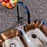 Countertop 23: A stylish kitchen countertop covered in dark charcoal terrazzo-patterned film with brown, gray, and neutral speckles, creating a sleek and modern industrial-inspired surface.