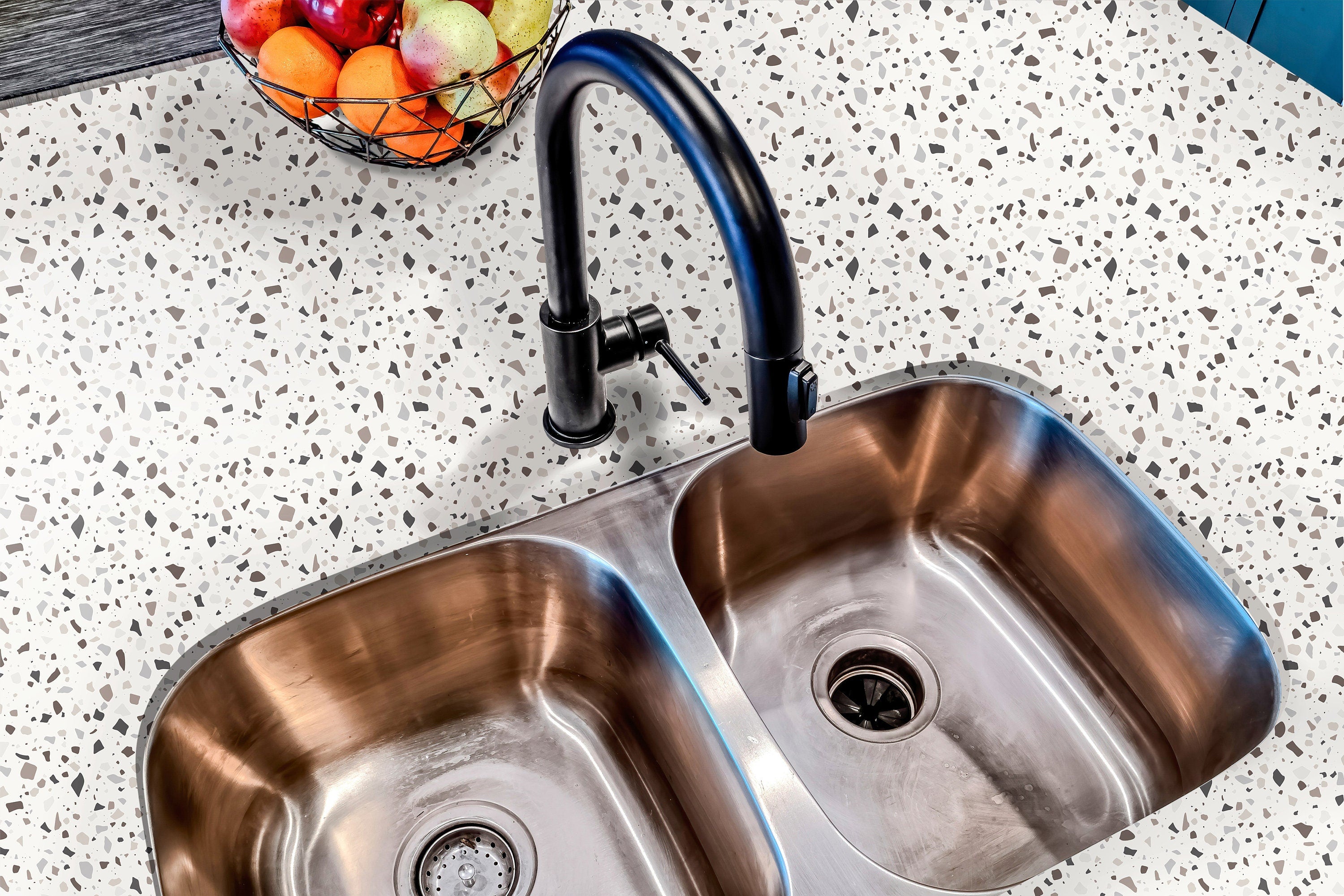 Countertop 21: A modern kitchen countertop covered in white terrazzo-patterned film with gray and neutral speckles, creating a minimalist and contemporary look.