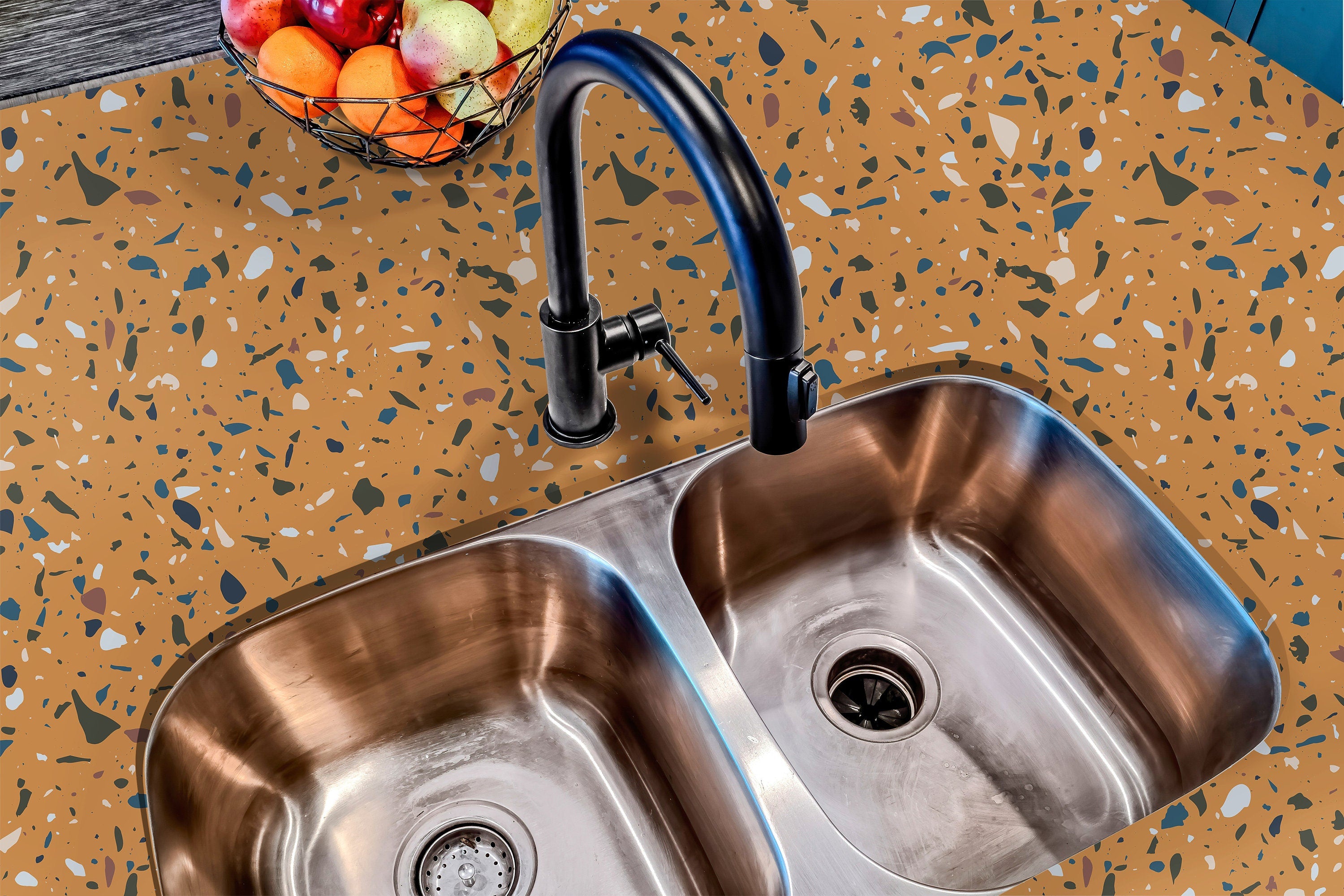Countertop 24: A modern kitchen countertop covered in a warm yellow terrazzo-patterned film with deep blue, neutral, and earthy speckles, offering a bold and stylish aesthetic.