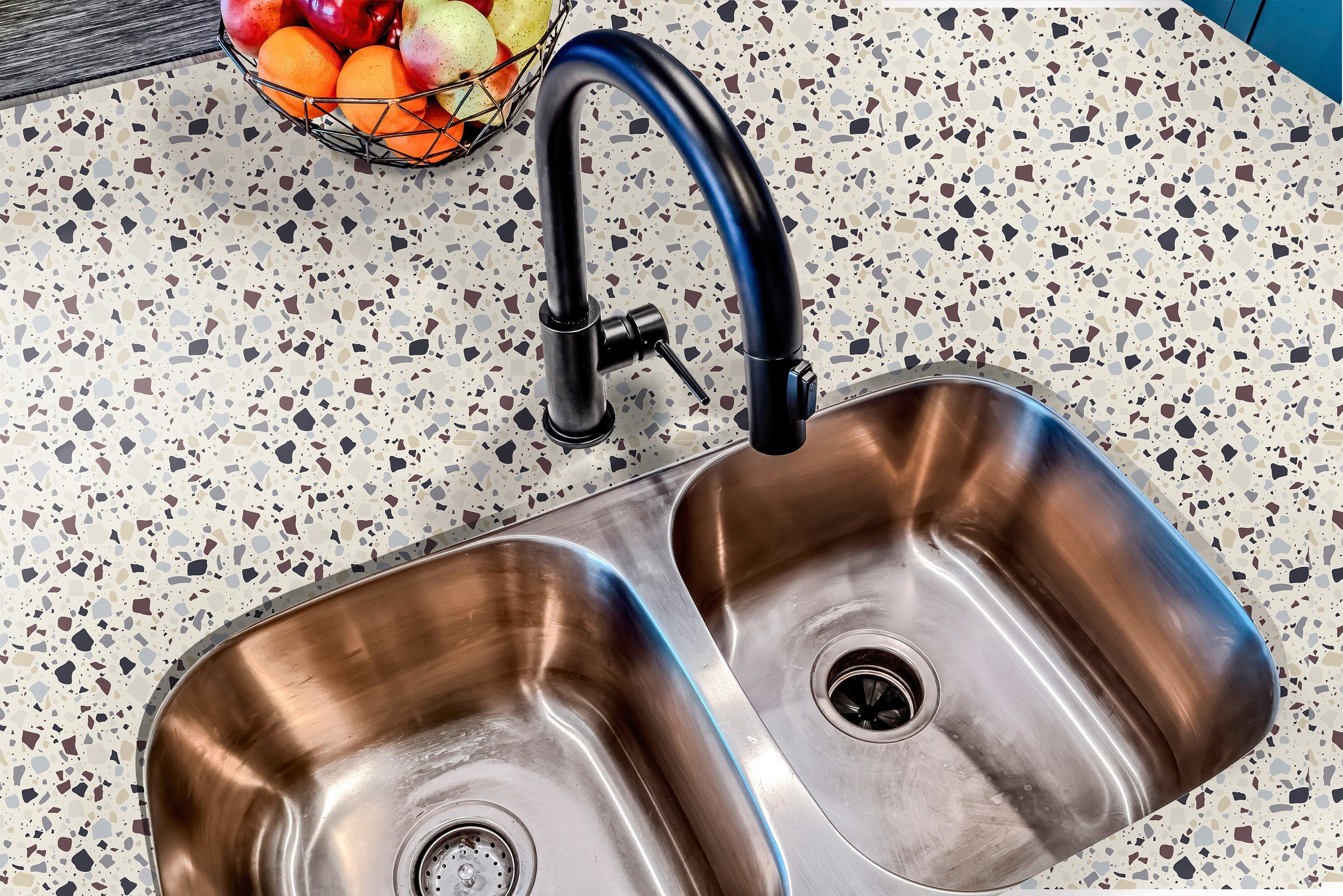 Countertop 19: A stylish kitchen countertop covered in beige terrazzo-patterned film with speckled brown, gray, and neutral tones, creating a modern and retro-inspired surface.