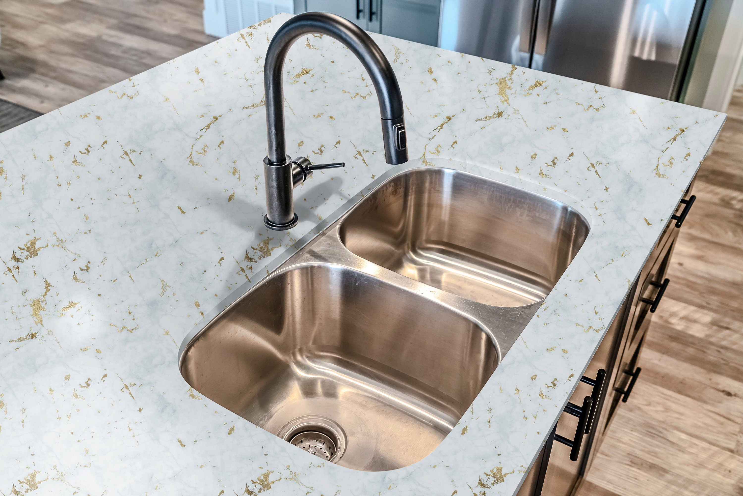 Countertop 12: A luxurious white and gold marble peel-and-stick countertop film covering a modern kitchen countertop with elegant gold veins.