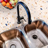 Countertop 26: A modern kitchen countertop covered in beige and navy terrazzo-patterned film, featuring warm earth tones and navy blue speckles for a stylish and contemporary look.