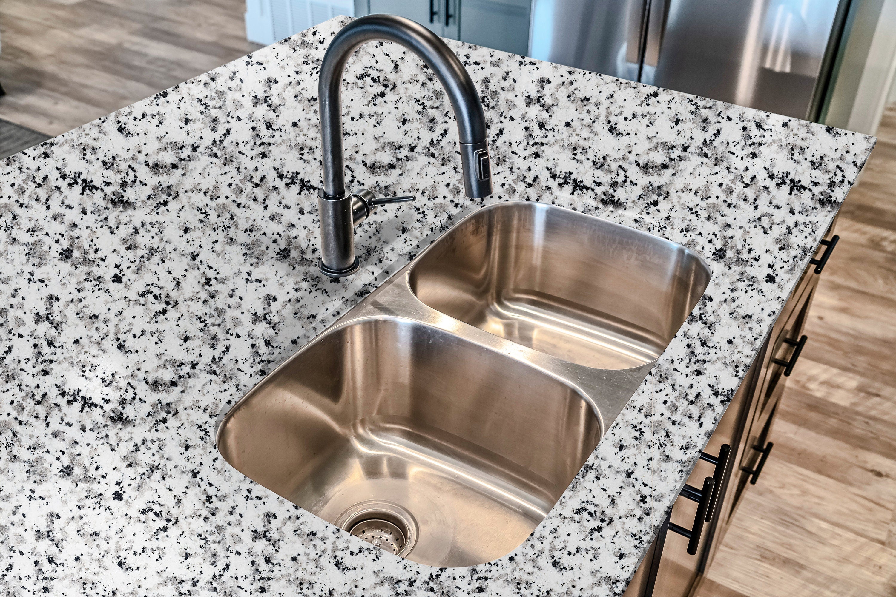 Countertop 13: Snowfall Granite peel-and-stick countertop wrap with a realistic white and black speckled stone design, ideal for modern kitchen updates.