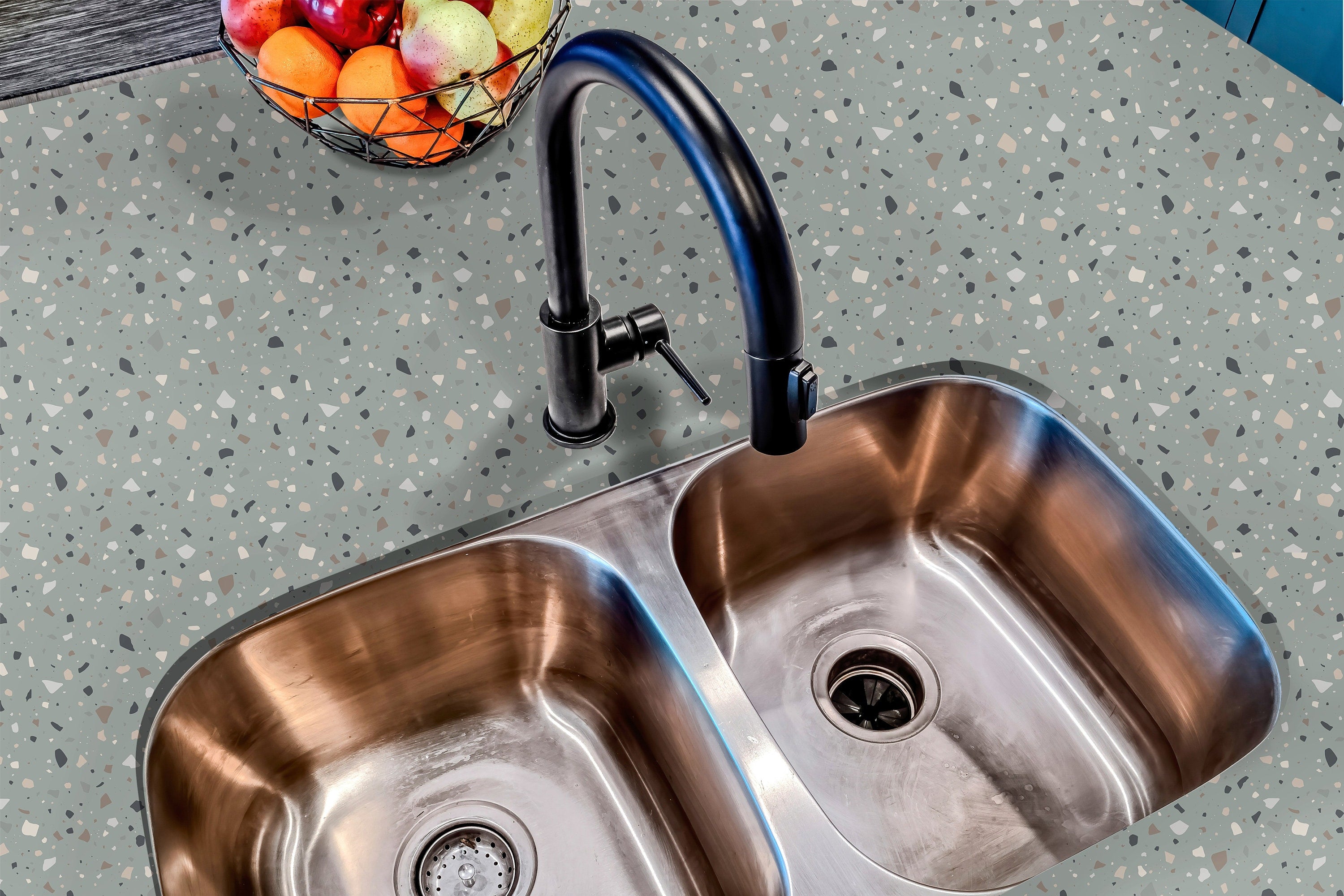 Countertop 22: A modern kitchen countertop covered in sage green terrazzo-patterned film with neutral and earthy speckles, creating a soft and stylish aesthetic.
