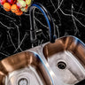 Countertop 18: A sleek kitchen countertop covered in black marble-patterned film with striking white veining, offering a luxurious and modern aesthetic.