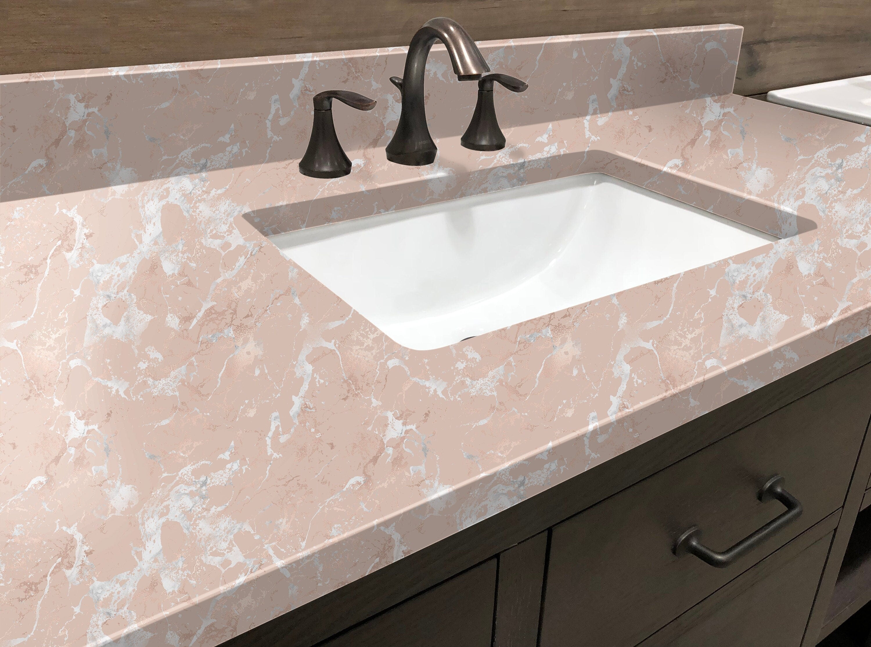 Countertop 8: Close-up of blush pink marble contact paper applied to a bathroom vanity, featuring soft pink and white veining with a professional finish for an elegant home upgrade.