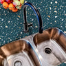 Countertop 28: A modern kitchen countertop covered in turquoise terrazzo-patterned film with multi-colored speckles, offering a stylish and contemporary aesthetic.