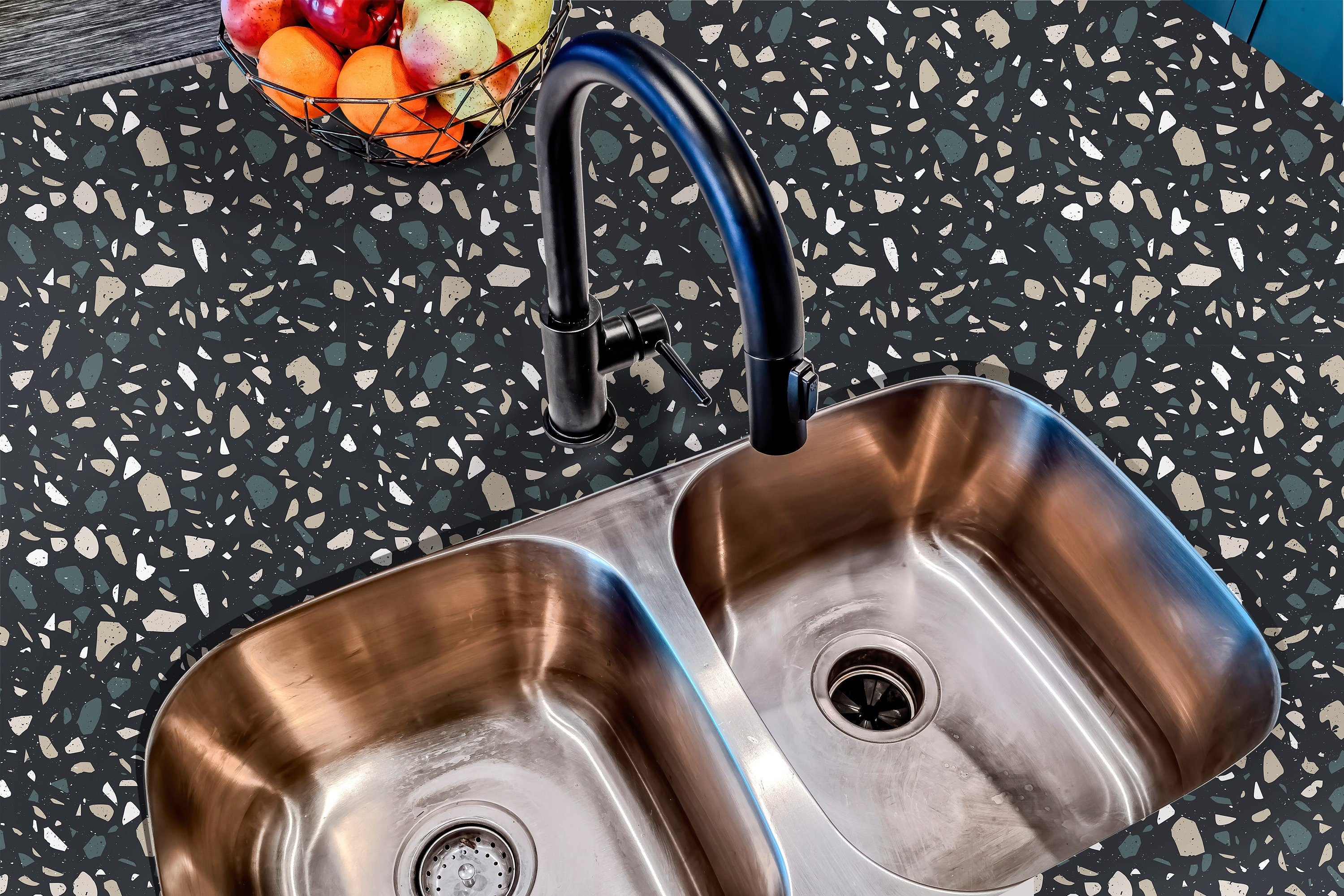 Countertop 29: A modern kitchen countertop covered in dark terrazzo-patterned film with multi-colored speckles, offering a stylish and contemporary aesthetic.
