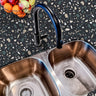Countertop 29: A modern kitchen countertop covered in dark terrazzo-patterned film with multi-colored speckles, offering a stylish and contemporary aesthetic.