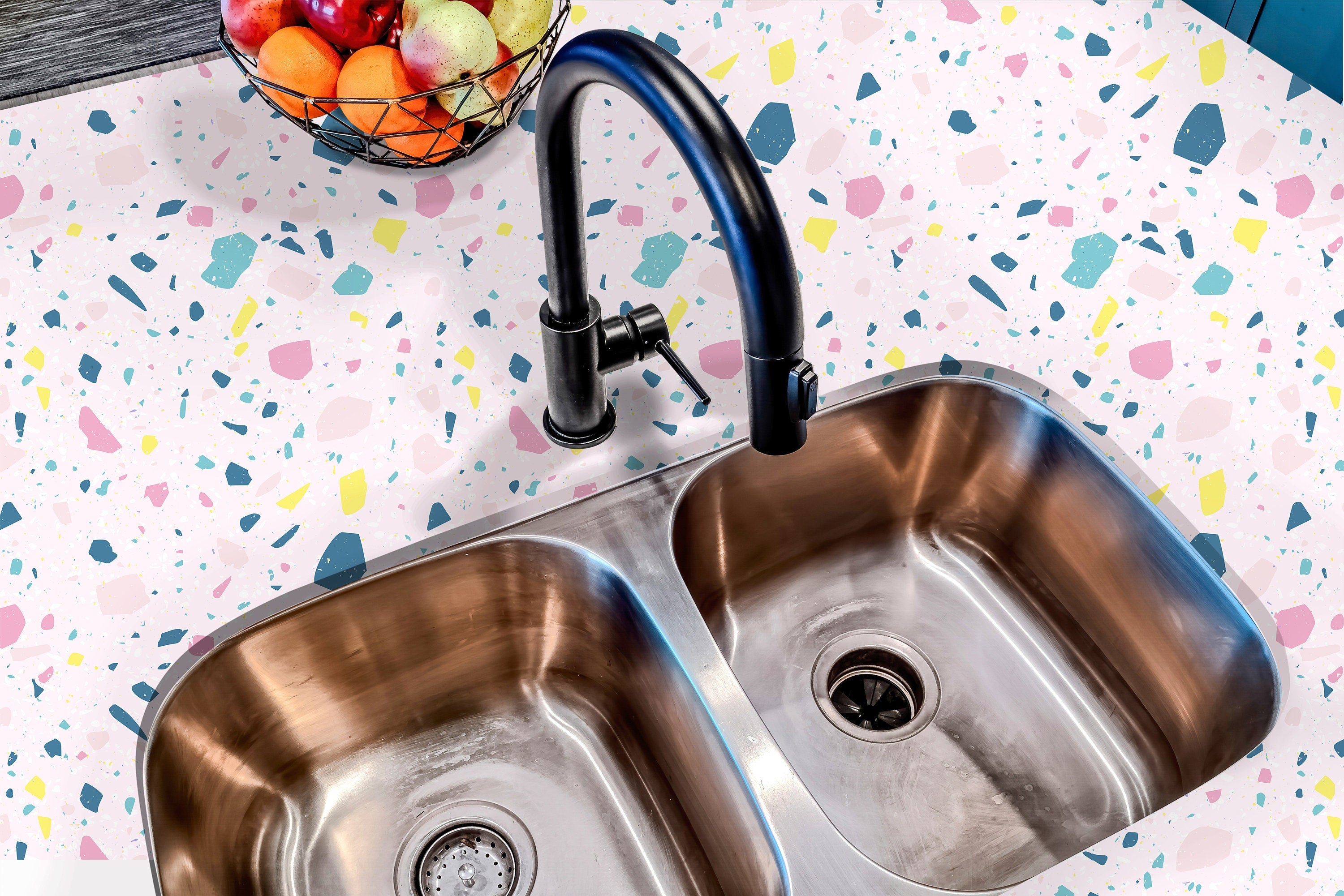 Countertop 27: A modern kitchen countertop covered in a pastel terrazzo-patterned film with soft pink, blue, and yellow speckles, offering a playful and contemporary aesthetic.