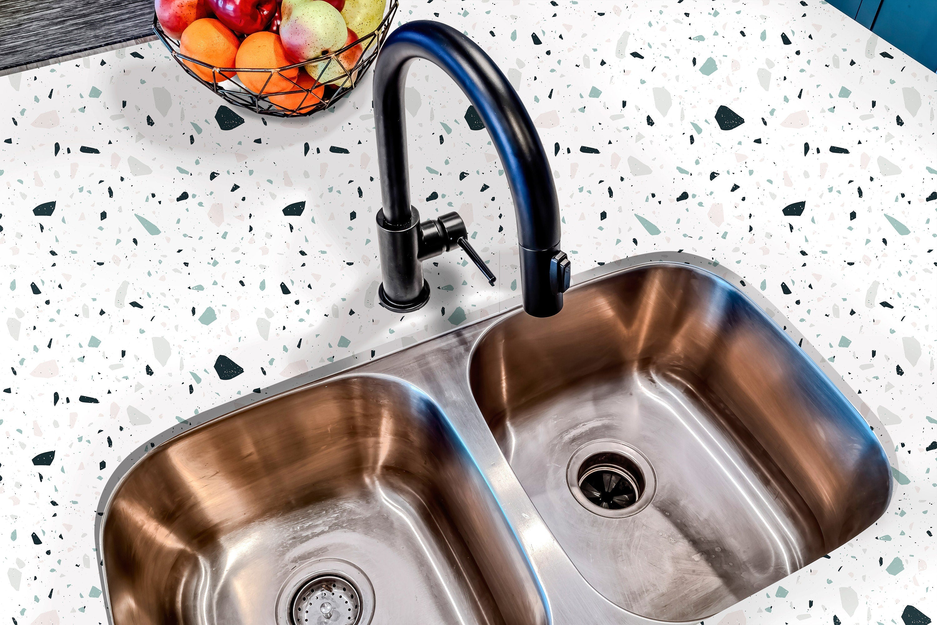 Countertop 33: A modern kitchen countertop covered in a white terrazzo-patterned film with scattered multicolored speckles, designed for a sleek and contemporary aesthetic.
