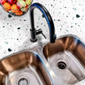 Countertop 33: A modern kitchen countertop covered in a white terrazzo-patterned film with scattered multicolored speckles, designed for a sleek and contemporary aesthetic.