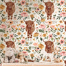 Wallpaper 3742: Rustic wallpaper featuring a repeating pattern of highland cows surrounded by soft watercolor wildflowers in warm peach, blush, and green tones, perfect for farmhouse and western-inspired spaces.