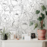 Wallpaper 646a: Minimalist floral wallpaper in black line art on a soft white background, styled with natural-toned decor and potted plants atop a modern cream console.