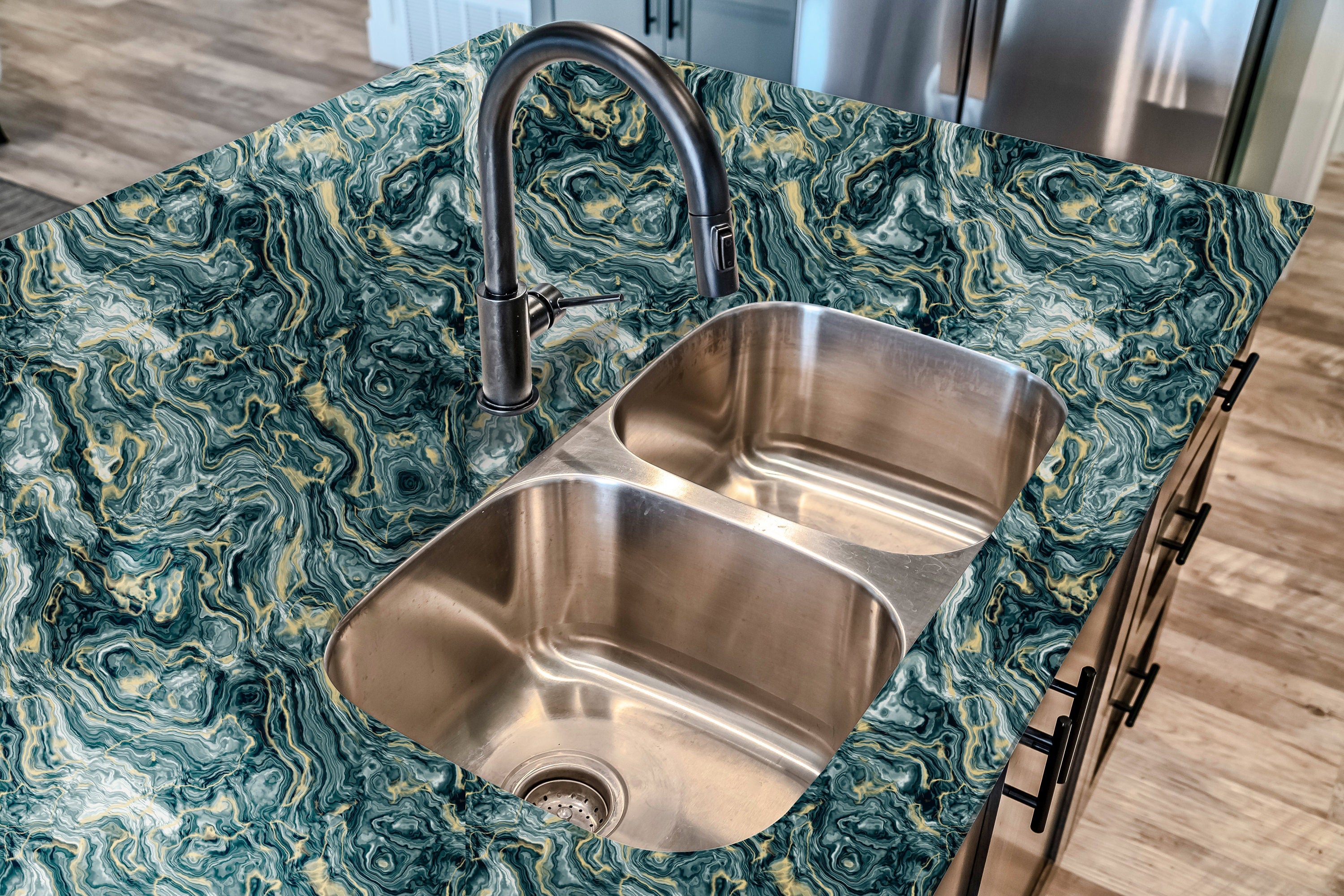 Countertop 36: A countertop in a striking dark green and gold marble-patterned film, featuring a bold swirling stone texture for a high-end and luxurious aesthetic.