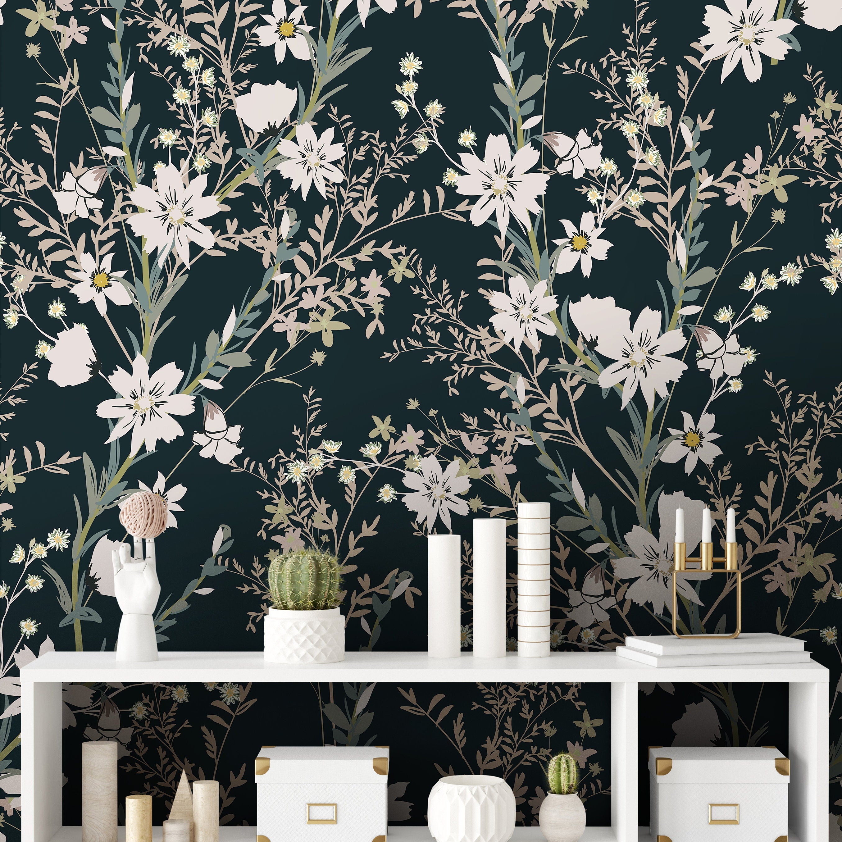 Wallpaper 898: A stylish dark green wallpaper adorned with cream and sage-toned wildflowers and delicate leaves, arranged in a sophisticated, large-scale botanical pattern behind a modern white shelving unit with decorative accents.