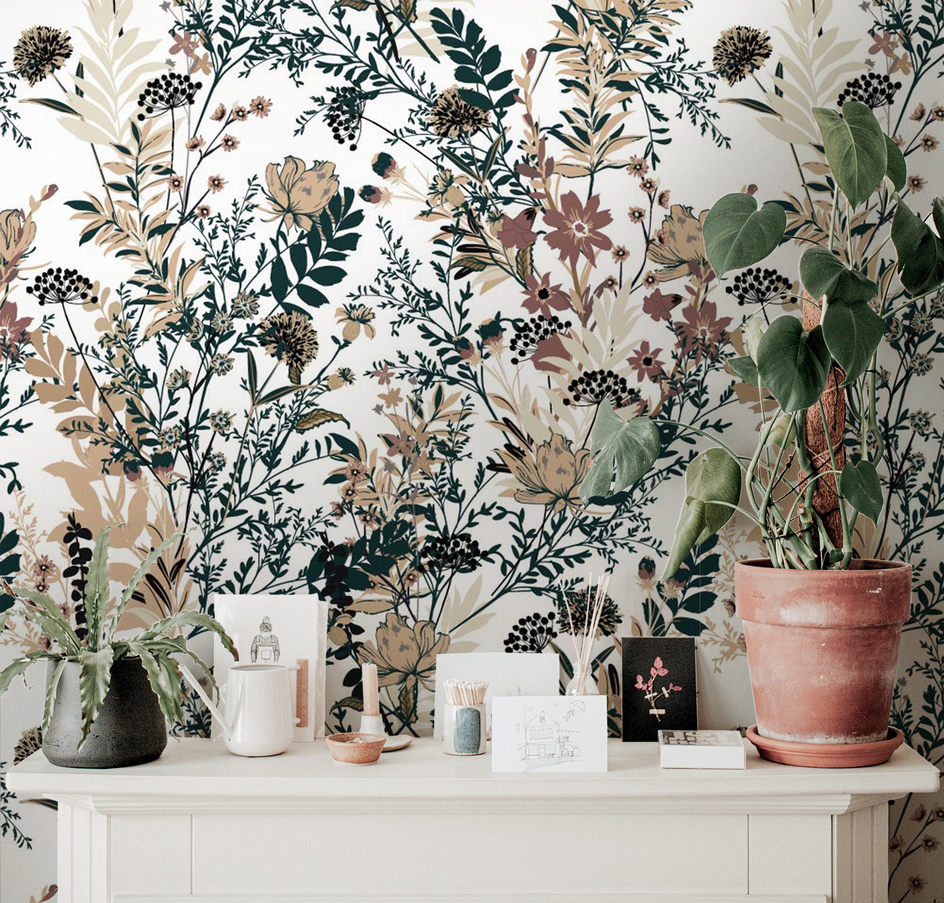 Wallpaper 918: A cozy and neutral-toned wallpaper featuring a detailed botanical print with warm earthy florals and foliage in mustard, cream, and terracotta hues, styled behind a dresser with plants and ceramics.