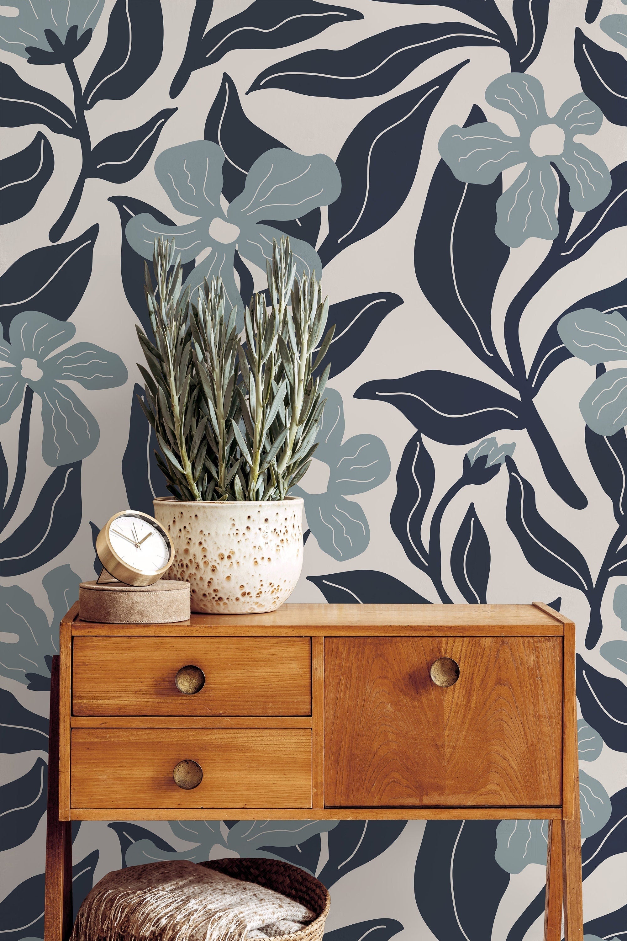 Wallpaper 1133: A close-up view of a modern floral wallpaper featuring oversized blue and gray flowers with elegant dark leaves, set against a beige background, creating a sophisticated and bold statement wall.